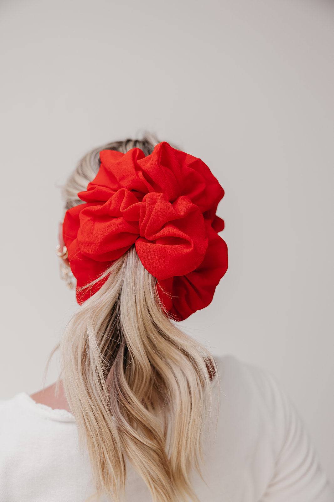 Jumbo scrunchie, bright red ruffled fabric bun scrunchie on blonde hair