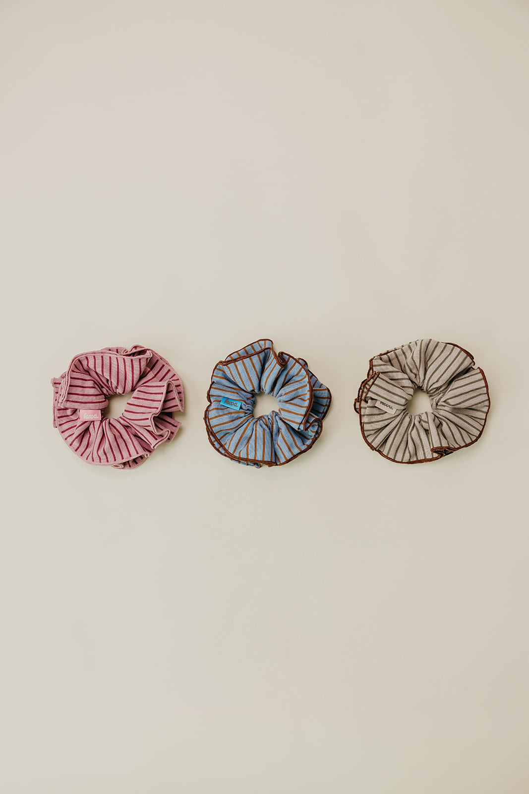 Three striped corset scrunchies: pink/maroon, blue/brown, and brown/tan stripes.