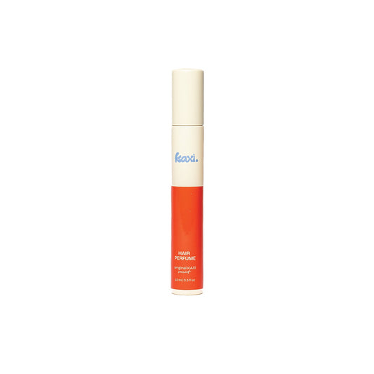 Hair perfume spray bottle standing upright with white top and orange base