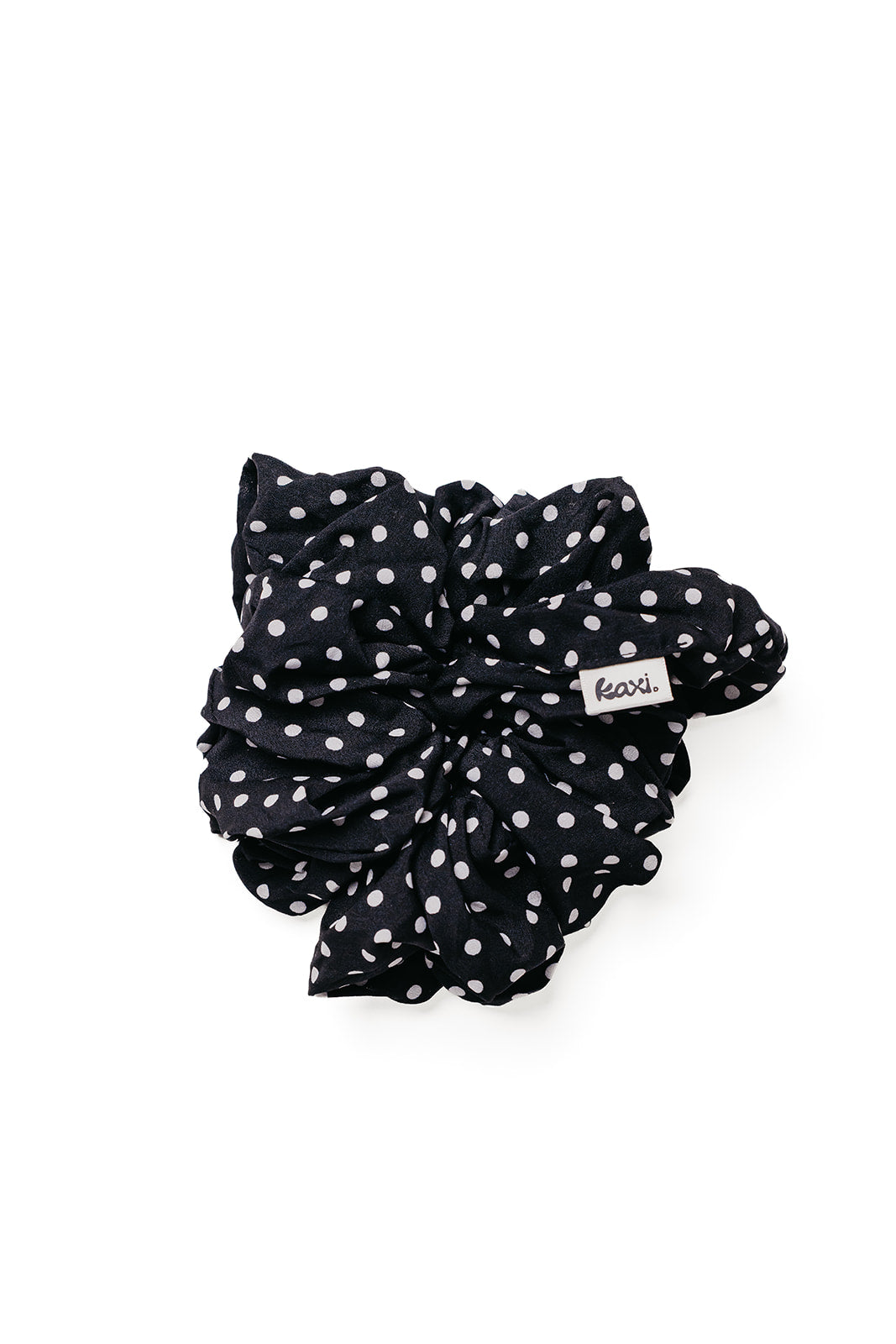 Jumbo scrunchie in black with white polka dots, standalone ruffled shape.