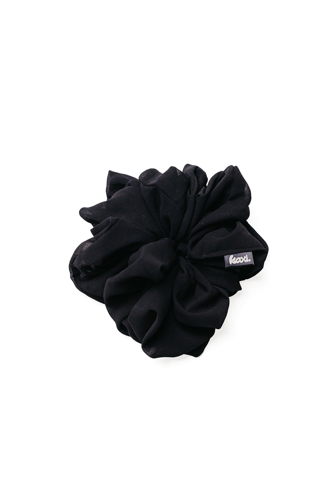 Black jumbo scrunchie with small brand label on the side