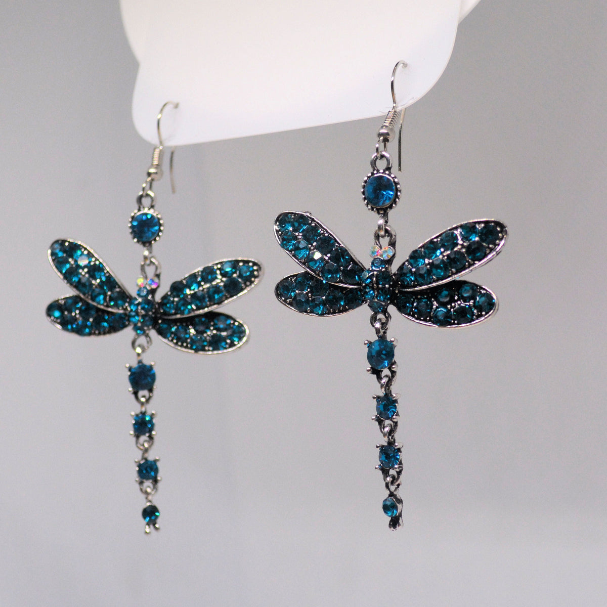 Pair of dangling dragonfly earrings with blue stones and long jeweled tails
