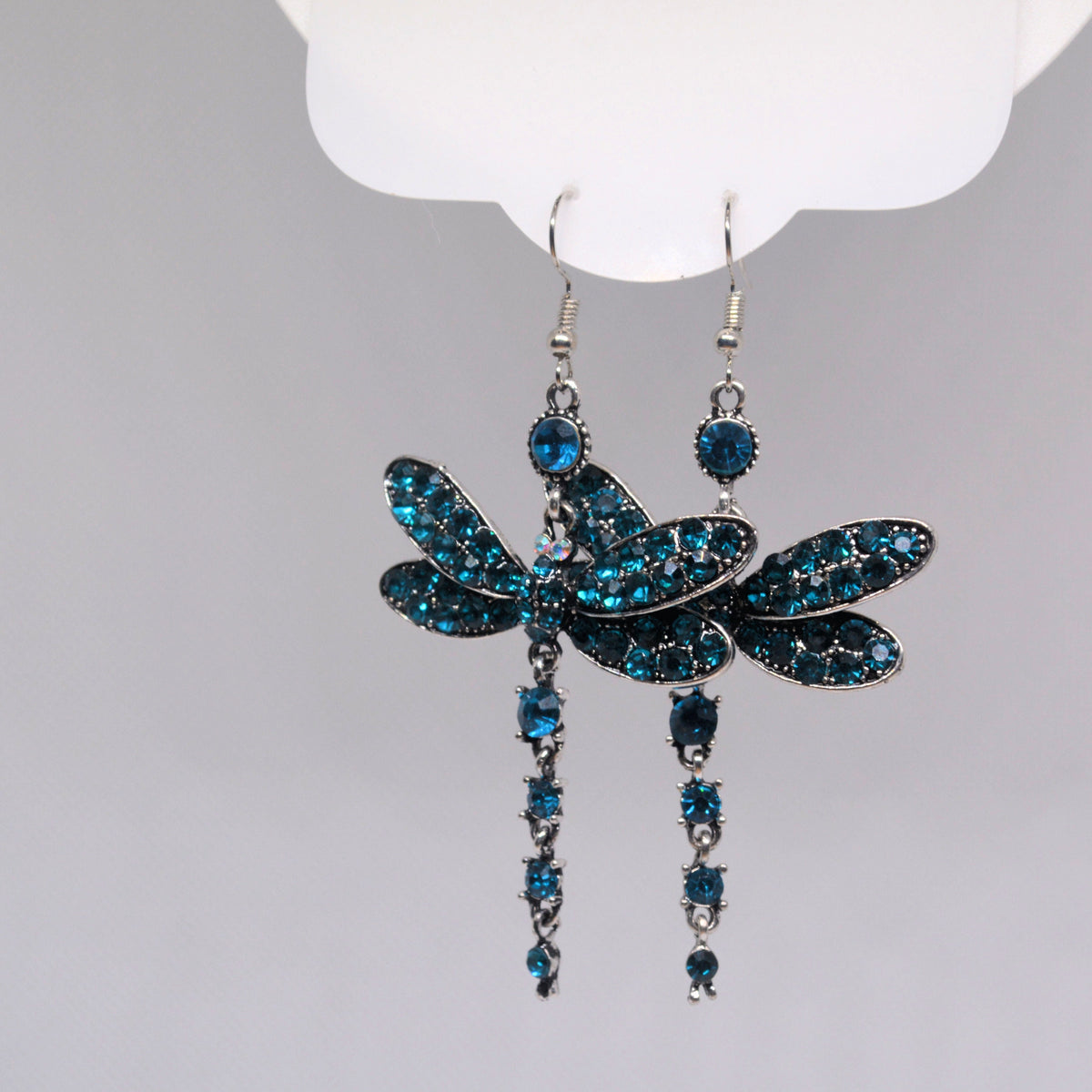 Blue stone dragonfly earrings shown overlapping, with fishhook wires and dangling tails