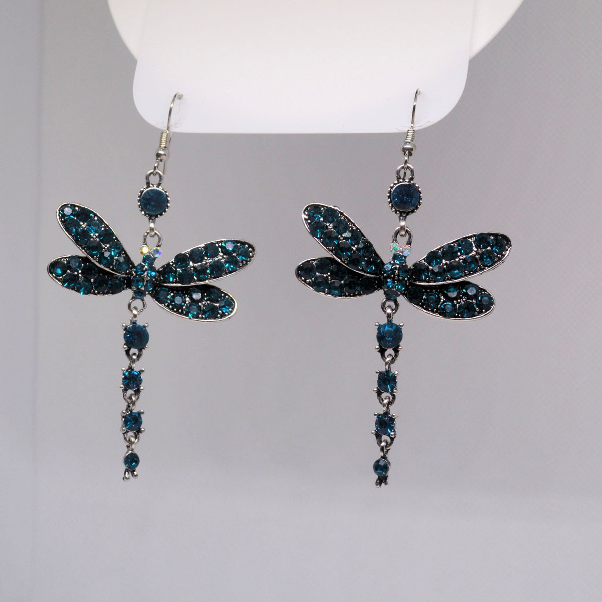 Pair of blue jeweled dragonfly earrings with long articulated drops