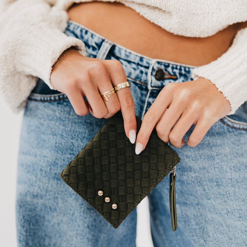 Woven suede wallet in dark olive with snap studs and gold zipper pull.