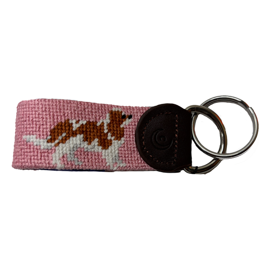 Pink needlepoint key fob with floral pattern, black leather end and metal key ring