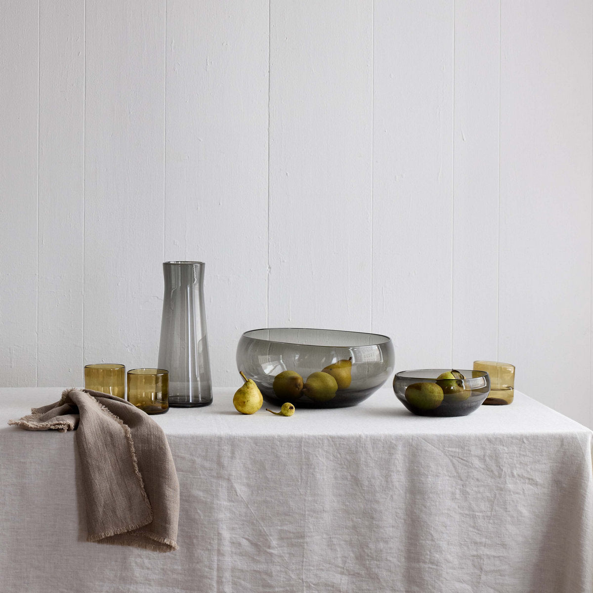 Linen table napkin in taupe, folded with fringe detail at the edge