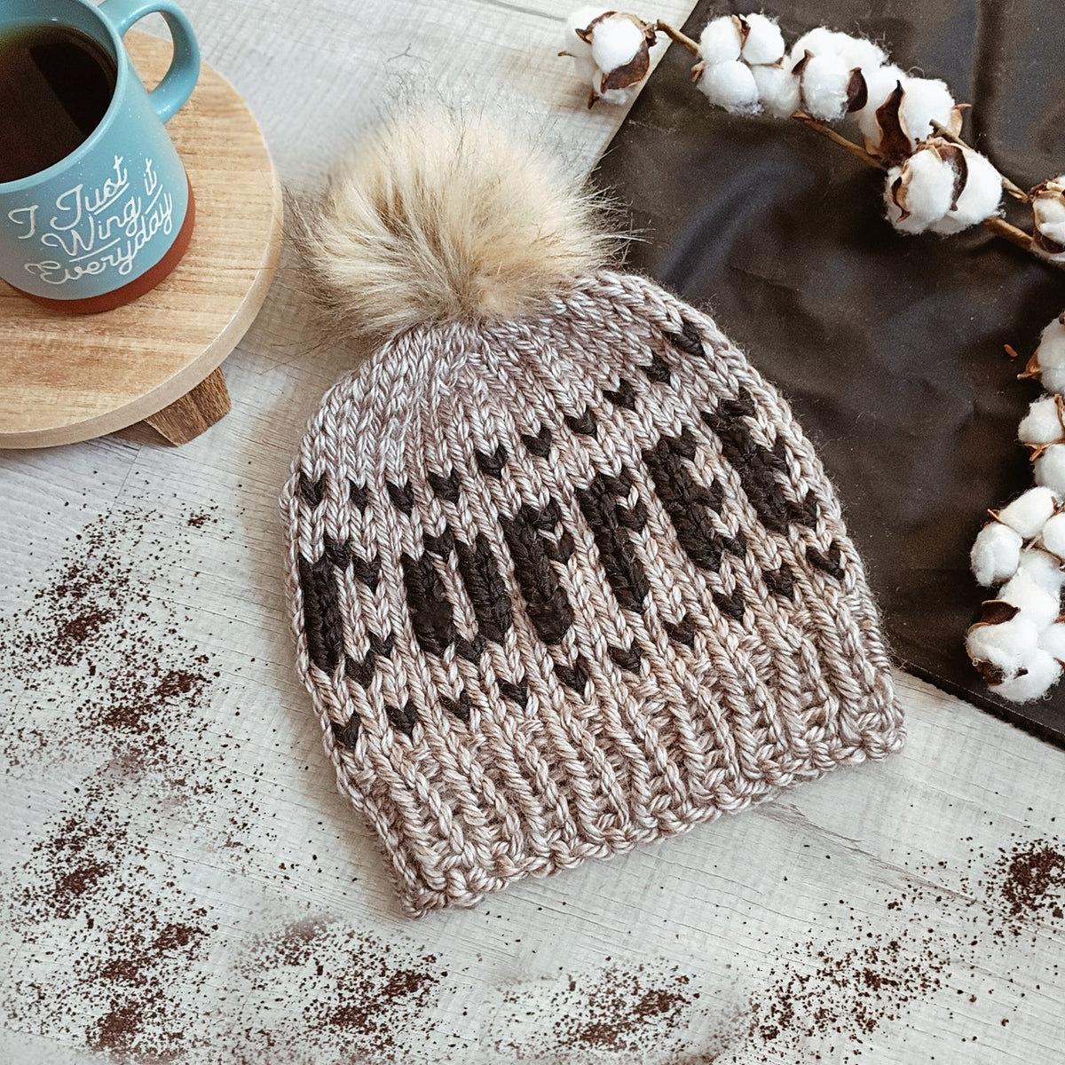 Gray chunky knit beanie with ribbed cuff and faux-fur pom-pom