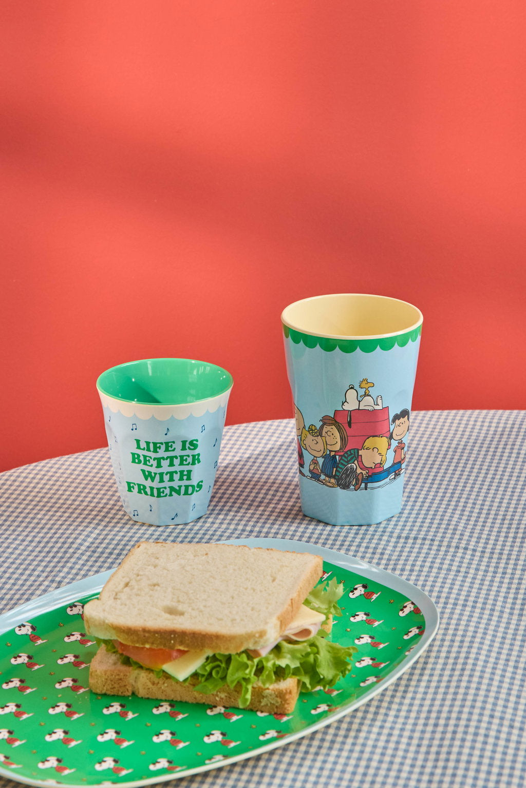 Green Snoopy-print plate with sandwich and two printed cups