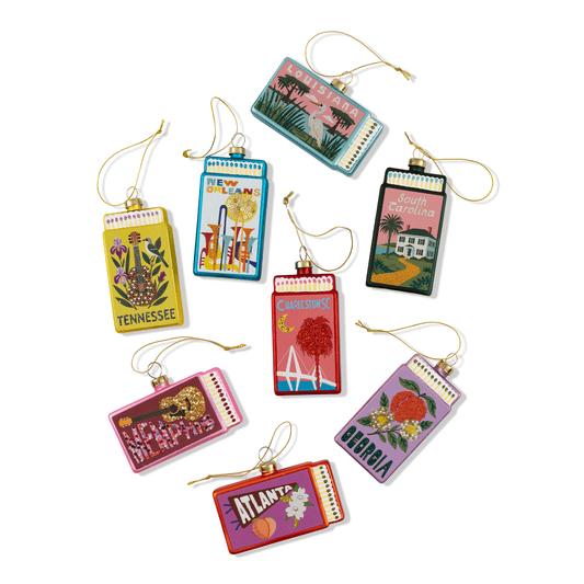 Assorted matchbook ornaments with colorful state-themed designs and hanging cords