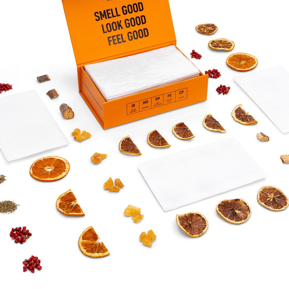 Luxury scented dryer sheets in an orange box with multiple white sheets laid out.