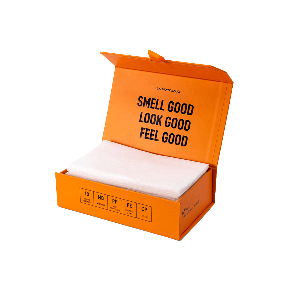 Luxury scented dryer sheets in an orange open-top box with white sheets inside.