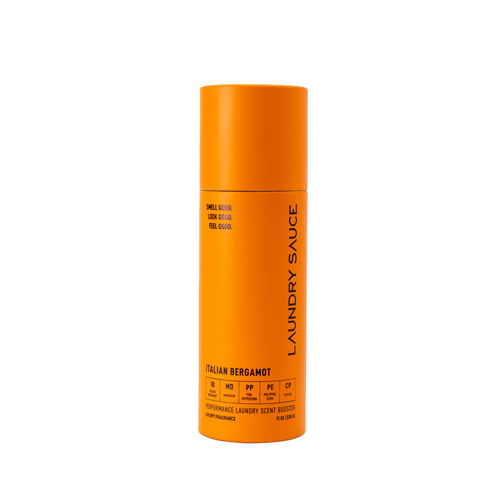 Orange cylinder laundry scent booster with vertical Laundry Sauce label
