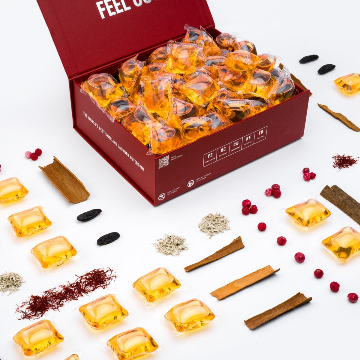 Red open cardboard tray of laundry detergent pods with multiple orange-gold pods