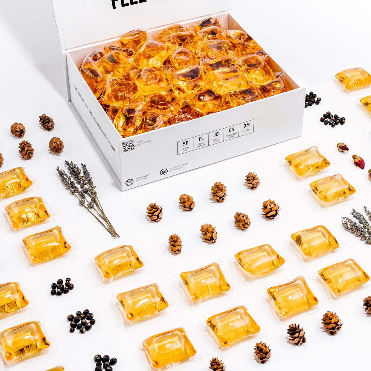 White box and tray-style view of amber gel scented laundry detergent pods