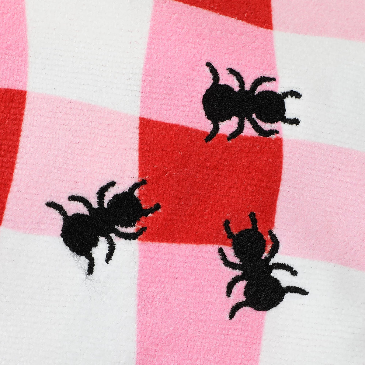 Black bee embroidery on red and pink gingham towel fabric
