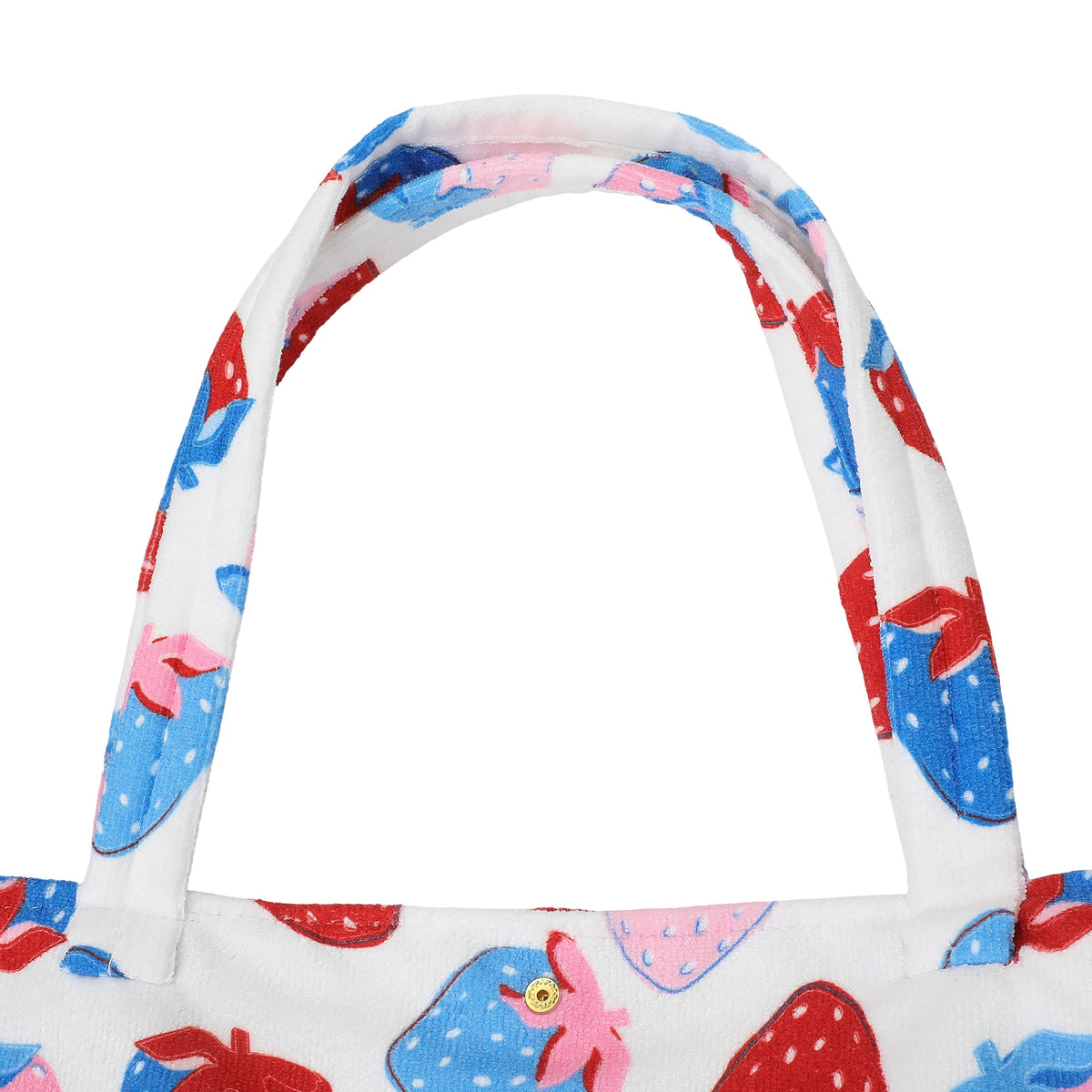 Strawberry-pattern tote bag handle close-up on white fabric with red, blue, and pink berries