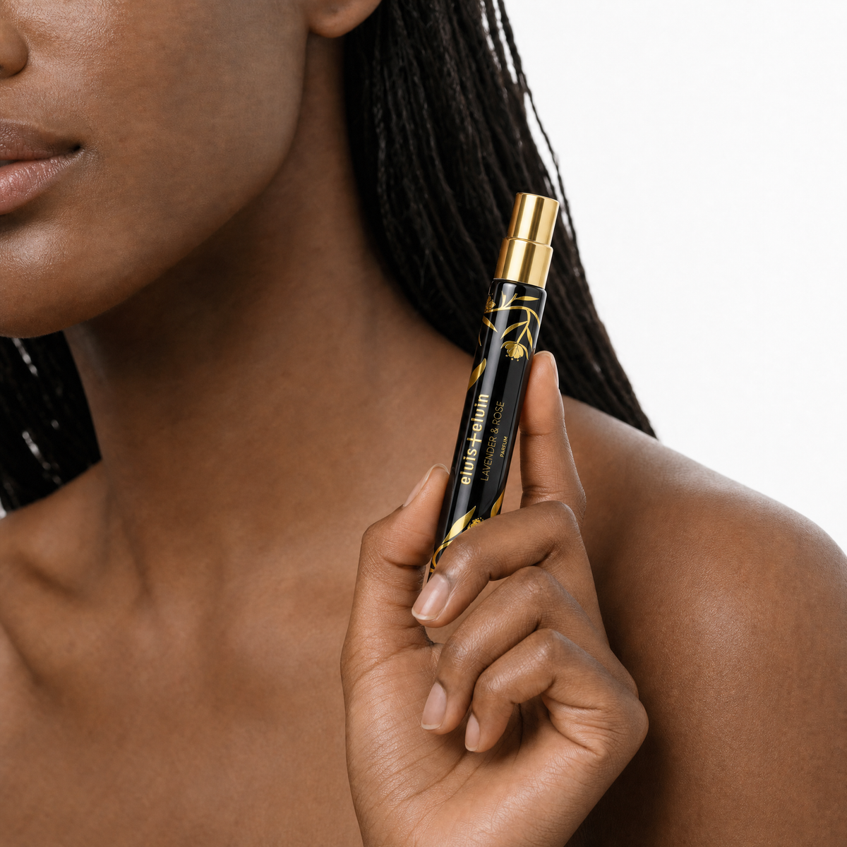 Lavender & Rose perfume vial in hand, black body with gold nozzle and gold pattern