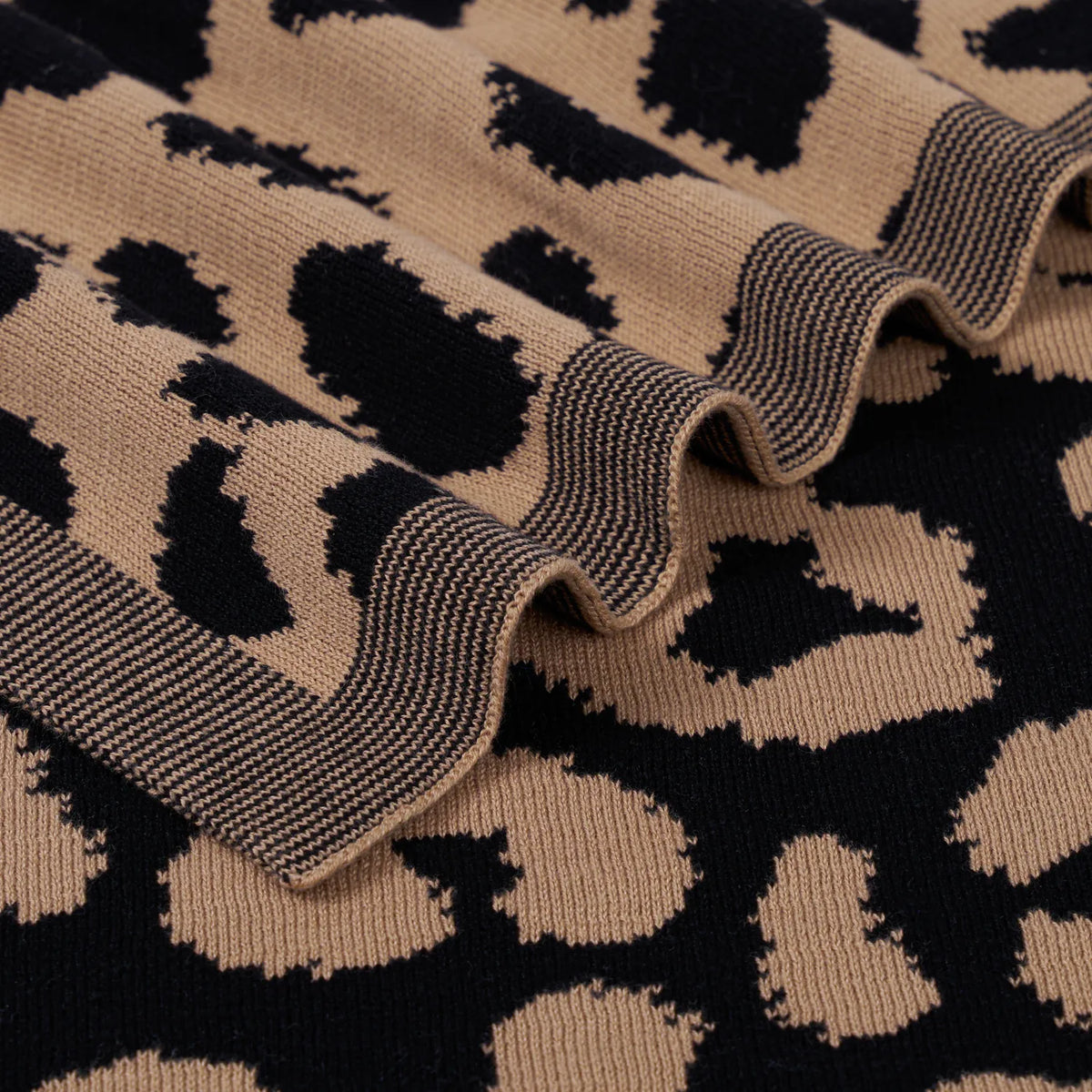 Leopard knit blanket edge with ribbed trim in dark and tan, leopard spot jacquard