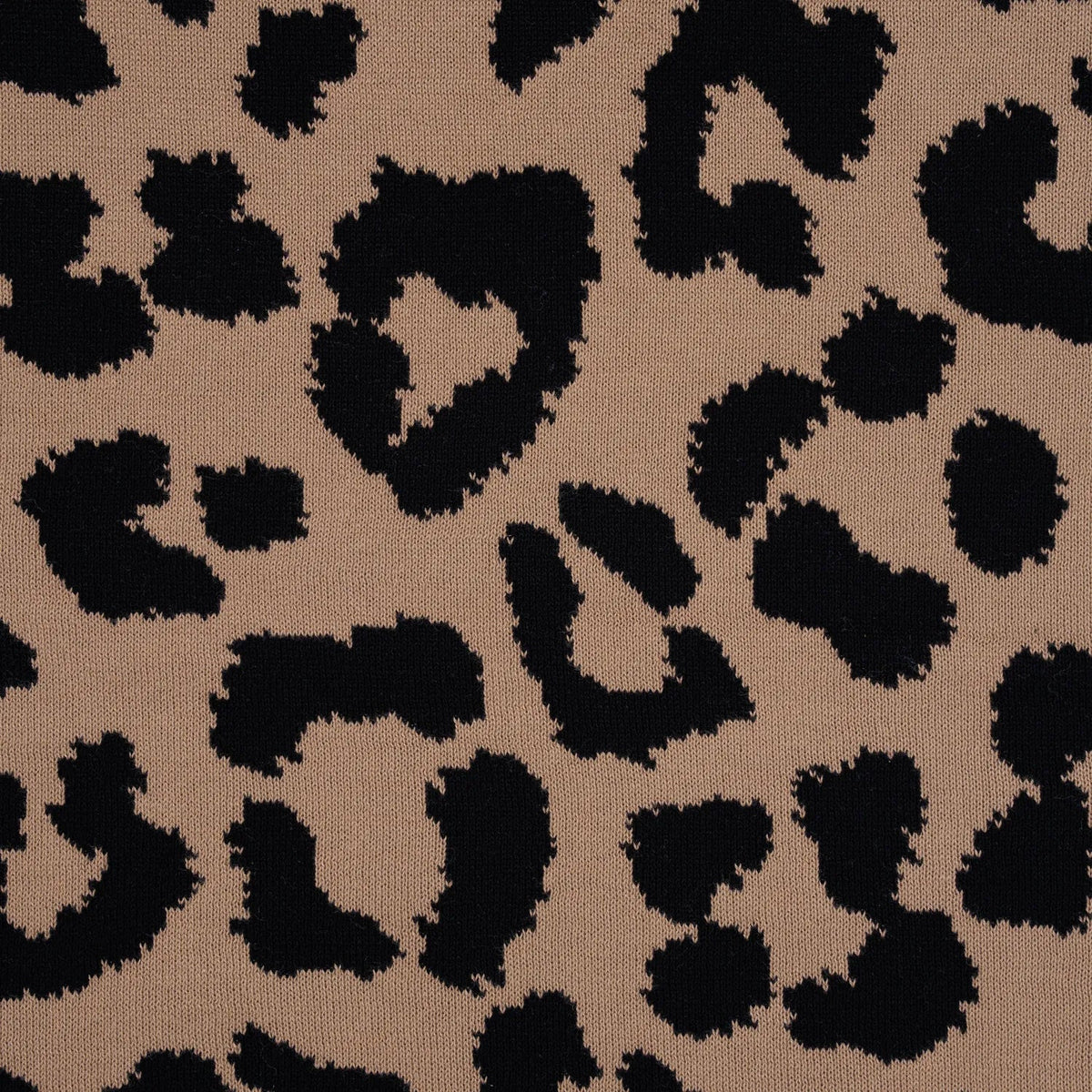 Leopard jacquard knit fabric with tan background and dark spots pattern