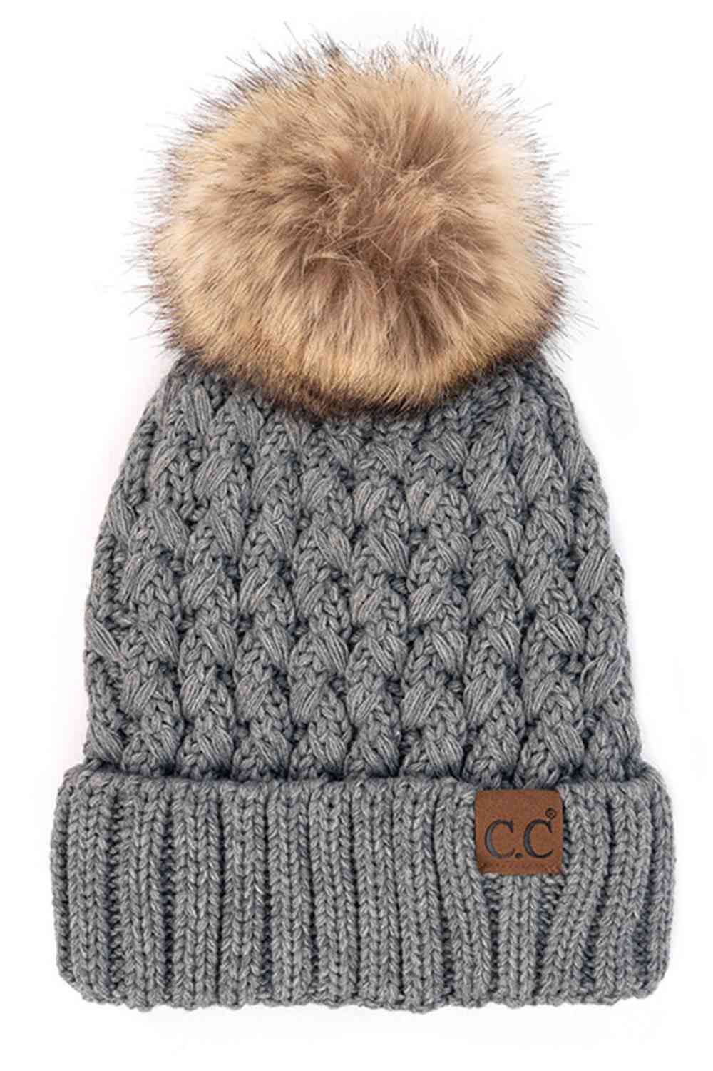 Charcoal knit beanie with fluffy pom-pom and C.C patch on ribbed cuff.