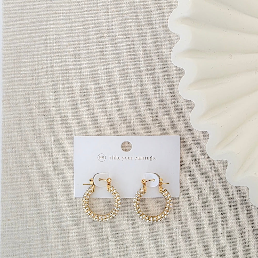 Pair of gold pavé hoop earrings on display card