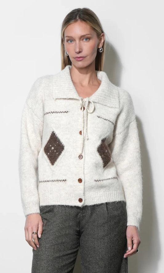 Cream knit cardigan with button front, V neckline, and brown diamond patches.