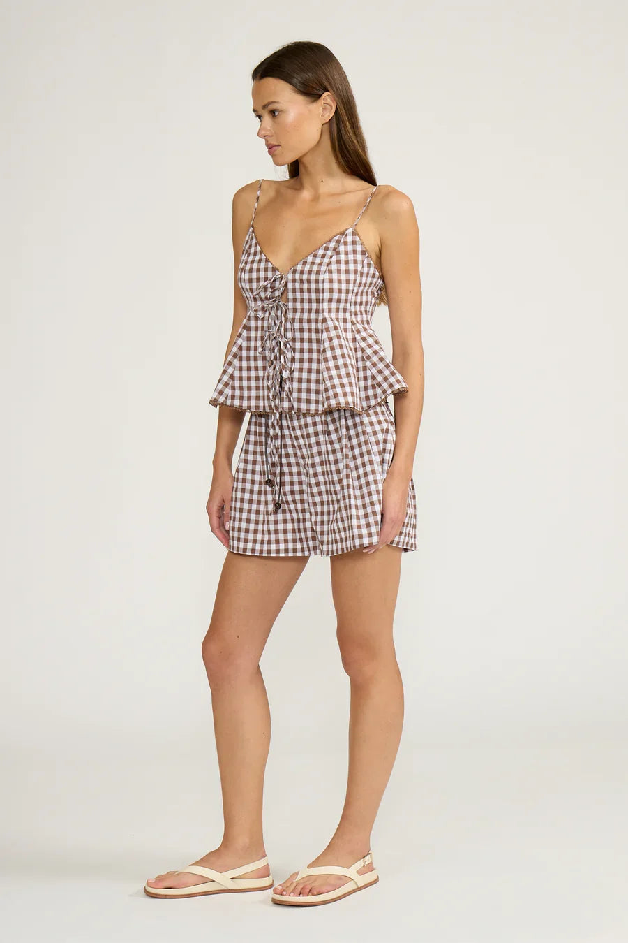 Brown gingham peplum tank top with lace-up front and tiered ruffle hem