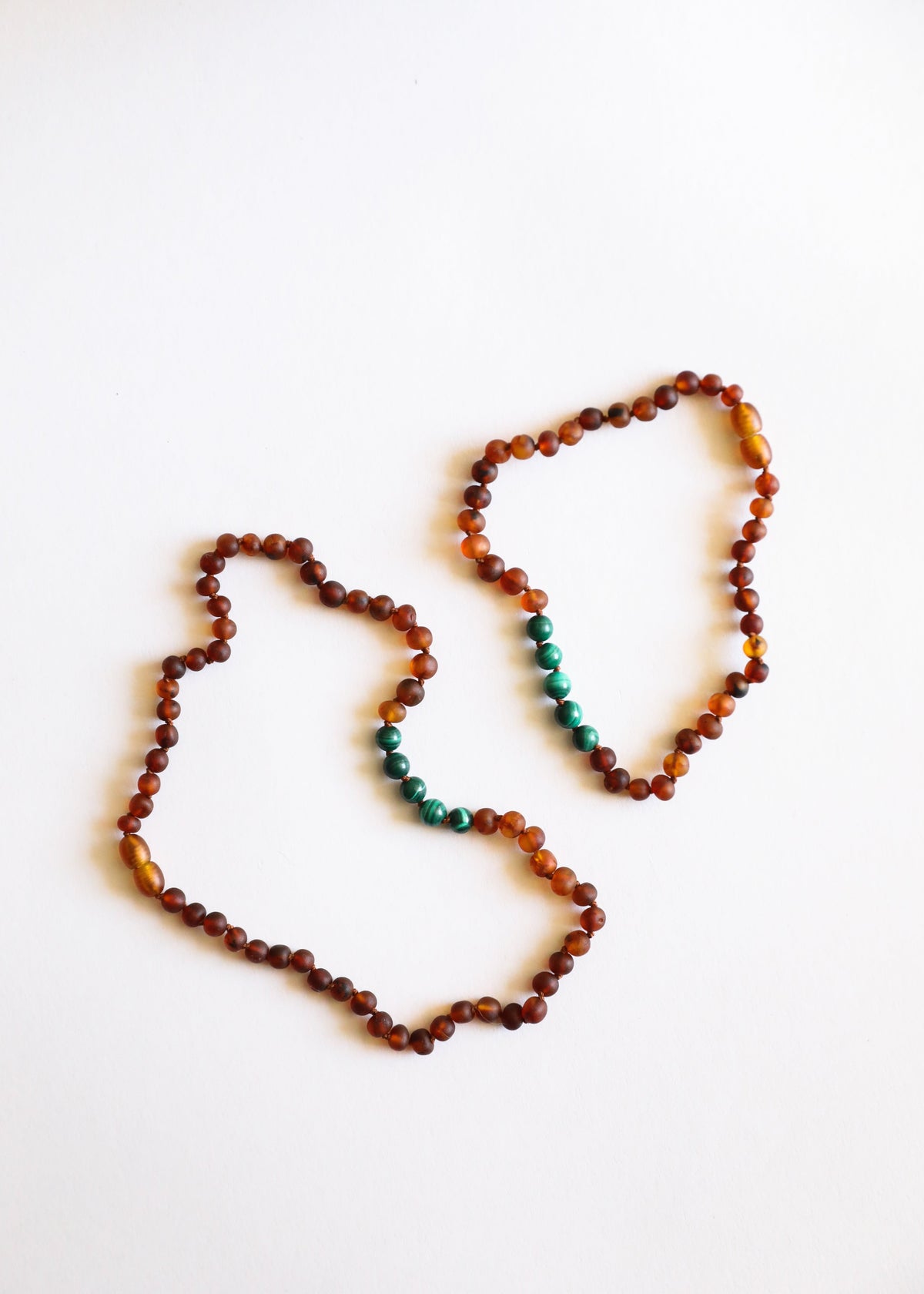 Amber bead necklace set with green accent beads, two strands