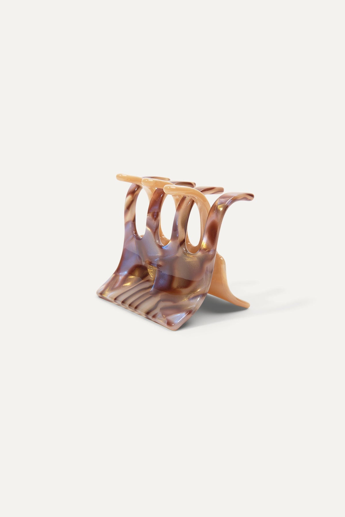 Mini translucent amber hair claw with curved base and prong teeth