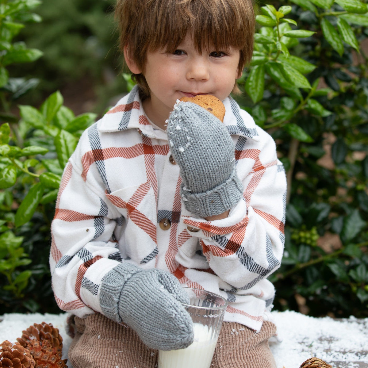Gray knit mittens with ribbed cuffs worn by a child