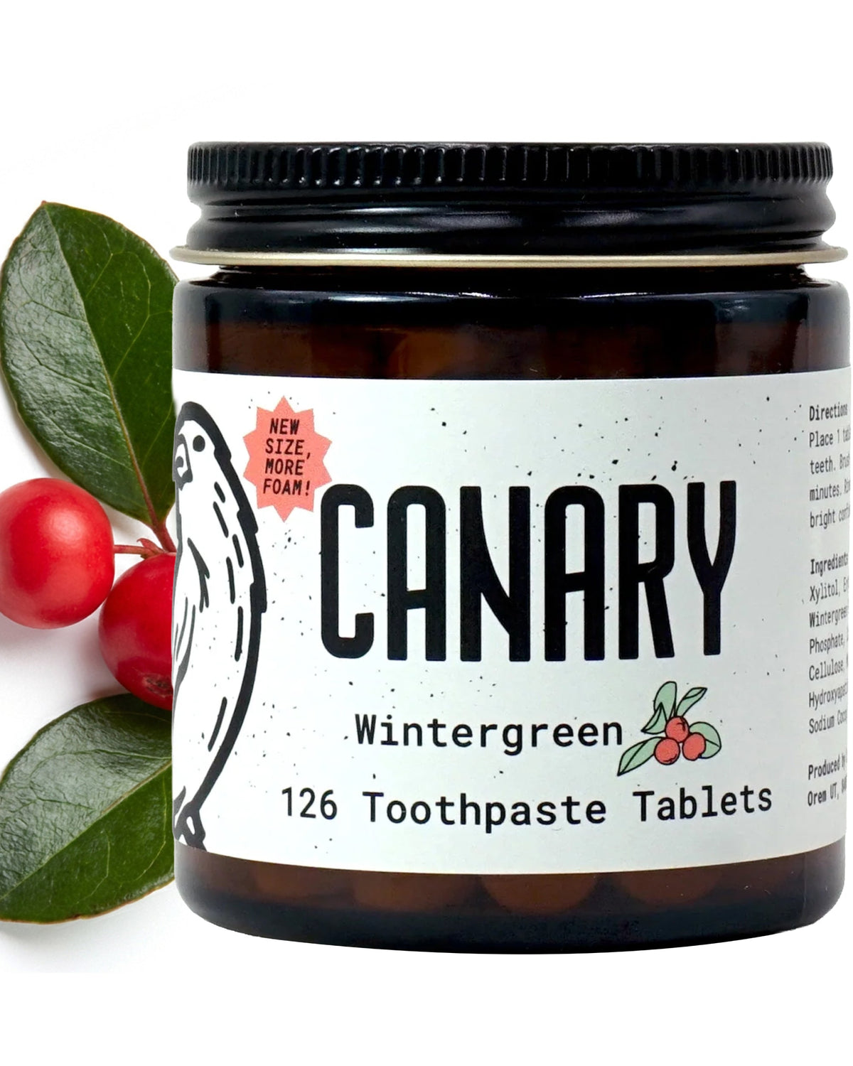 Canary Wintergreen toothpaste tablets in a dark glass jar with a black lid