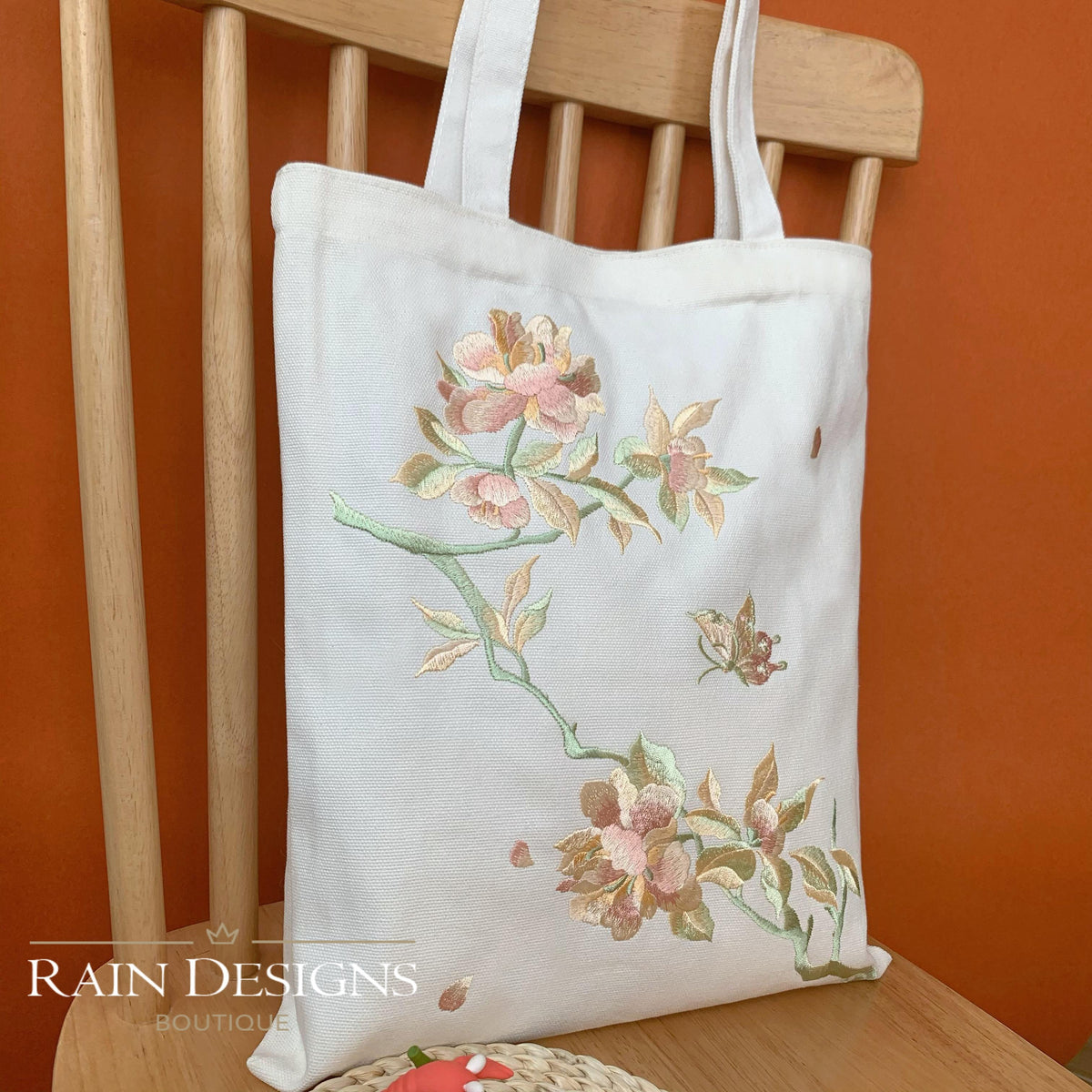 White peony embroidered tote bag with floral bouquet on front