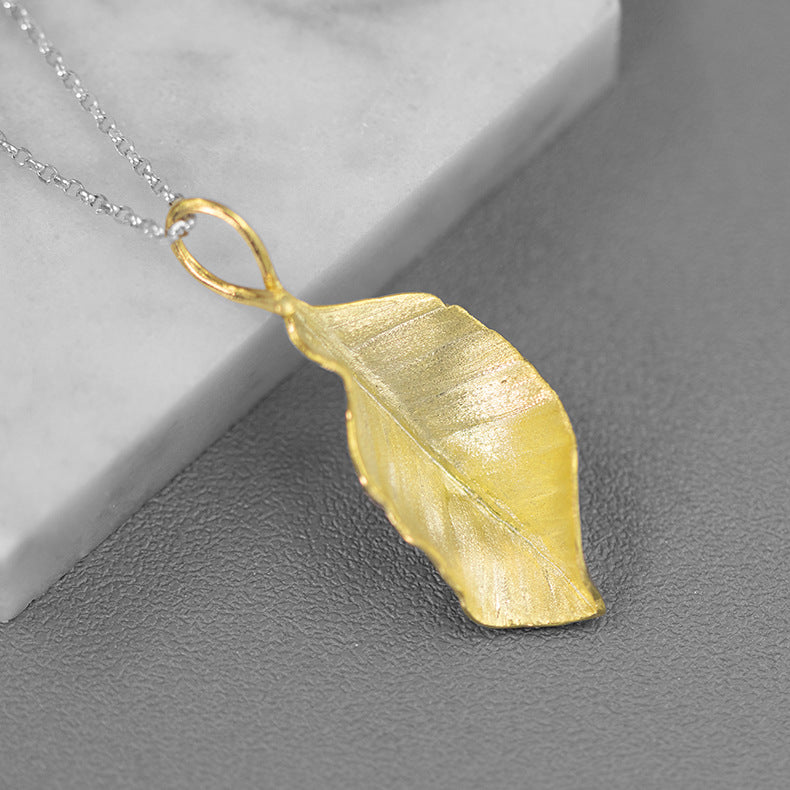 Gold leaf pendant necklace with textured leaf charm and open loop bail
