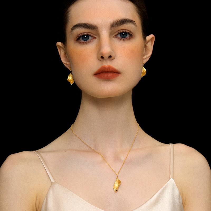 Gold leaf pendant necklace with thin chain and small teardrop clasp