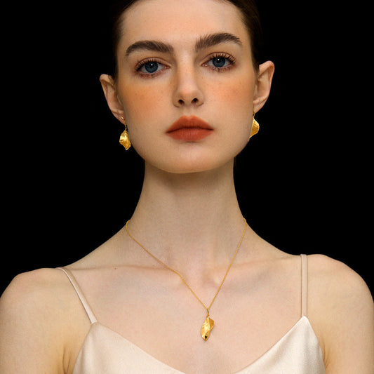 Gold leaf pendant necklace with thin chain and small teardrop clasp