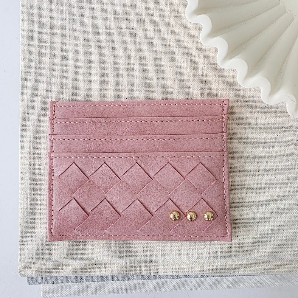 Dusty rose pink woven small card holder wallet with embossed pattern and gold studs.