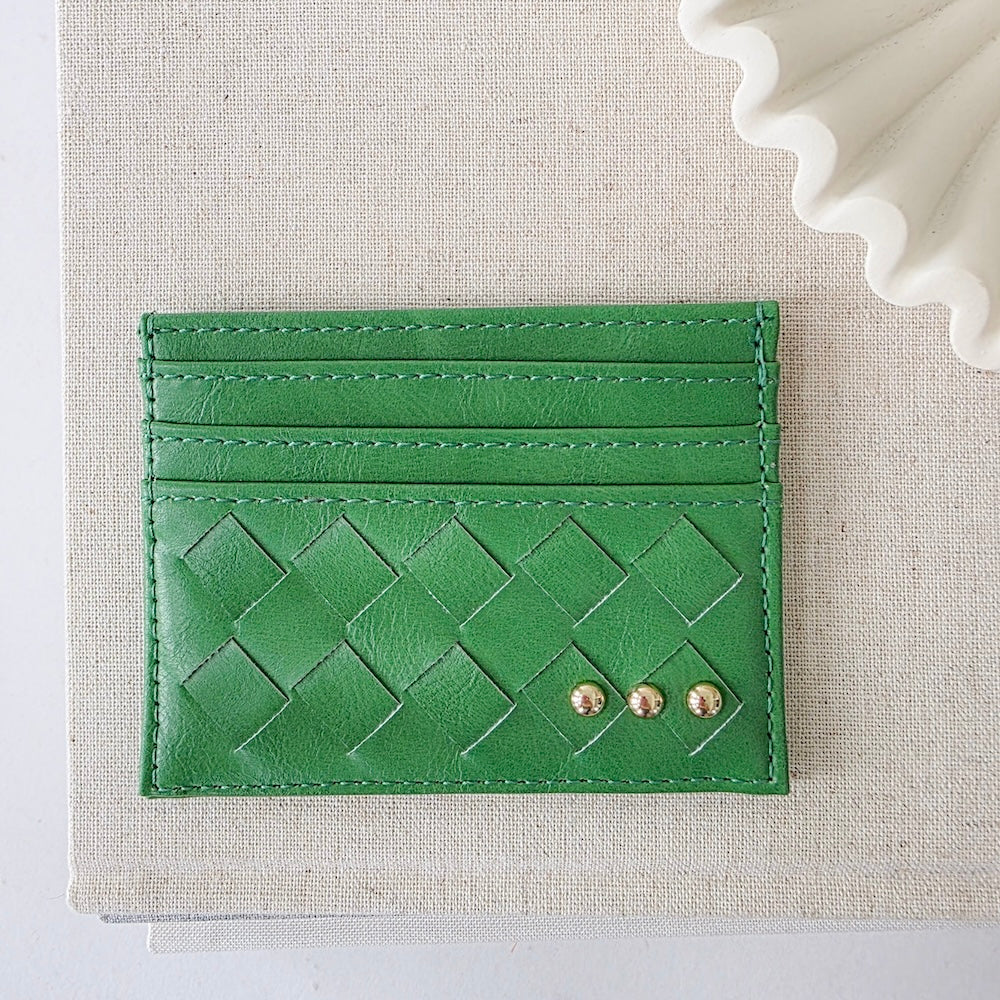 Emerald green woven small card holder wallet with embossed pattern and gold studs.