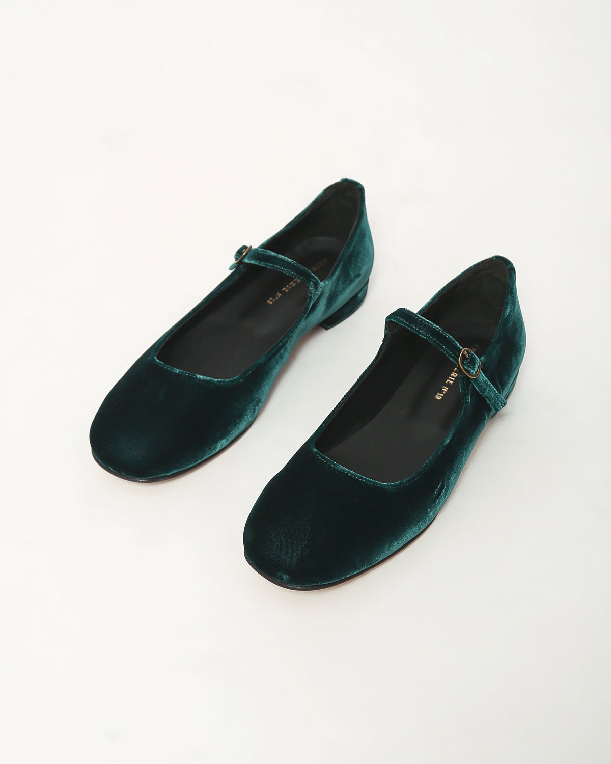 Pair of dark teal velvet Mary Jane shoes with oval buckle and low heels