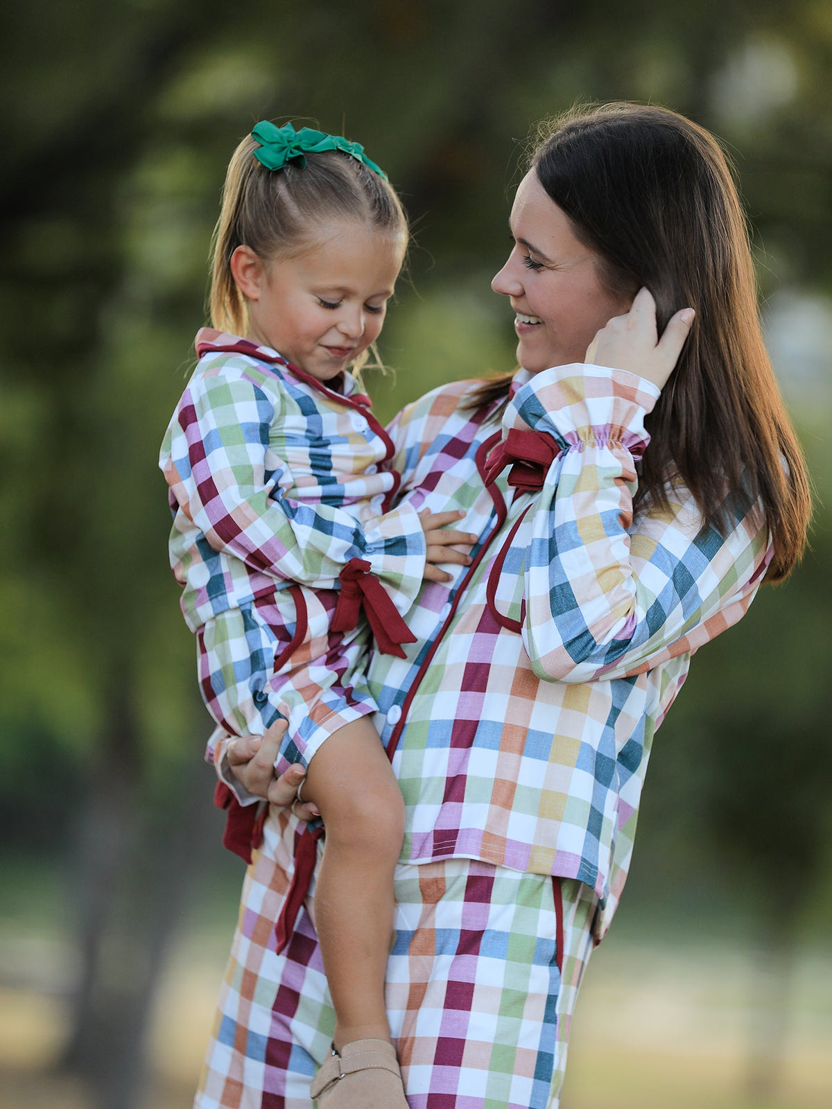 Mom-and-me plaid pajamas showing matching long-sleeve tops and drawstring shorts