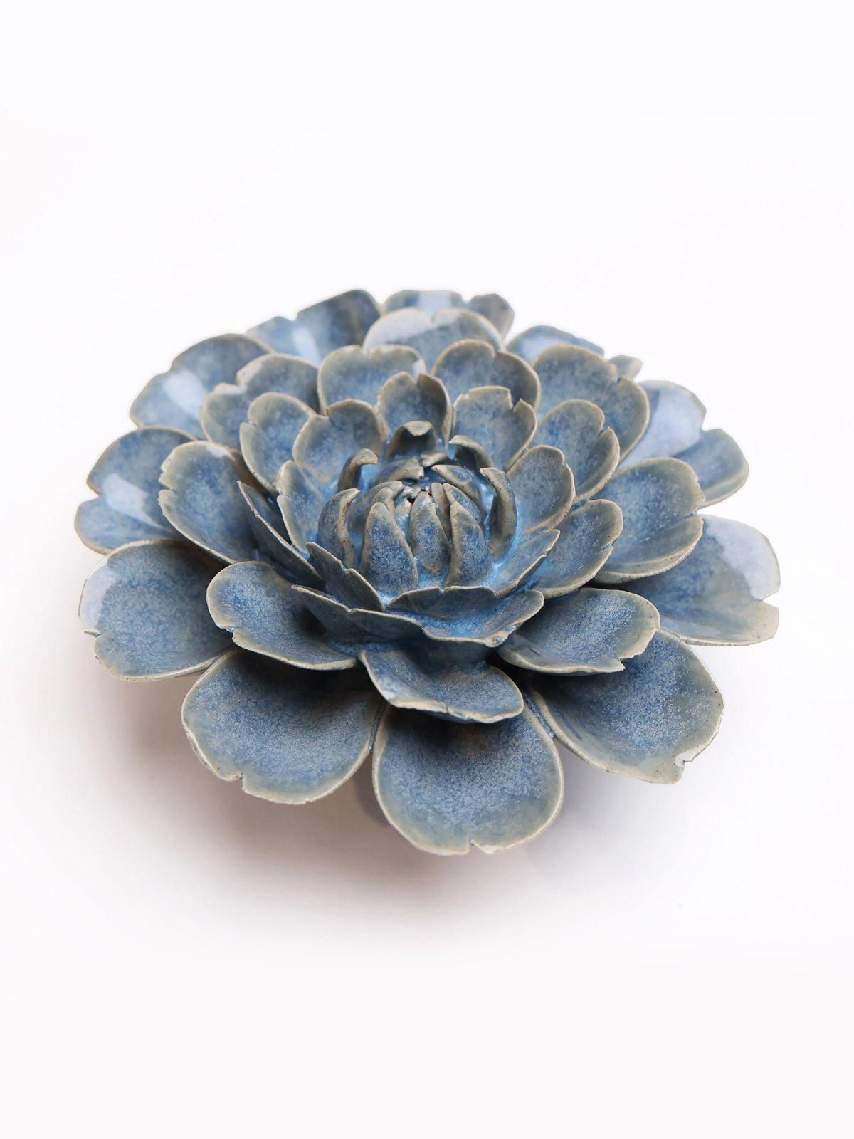 Blue ceramic rose flower decor with layered petals, close-up top view