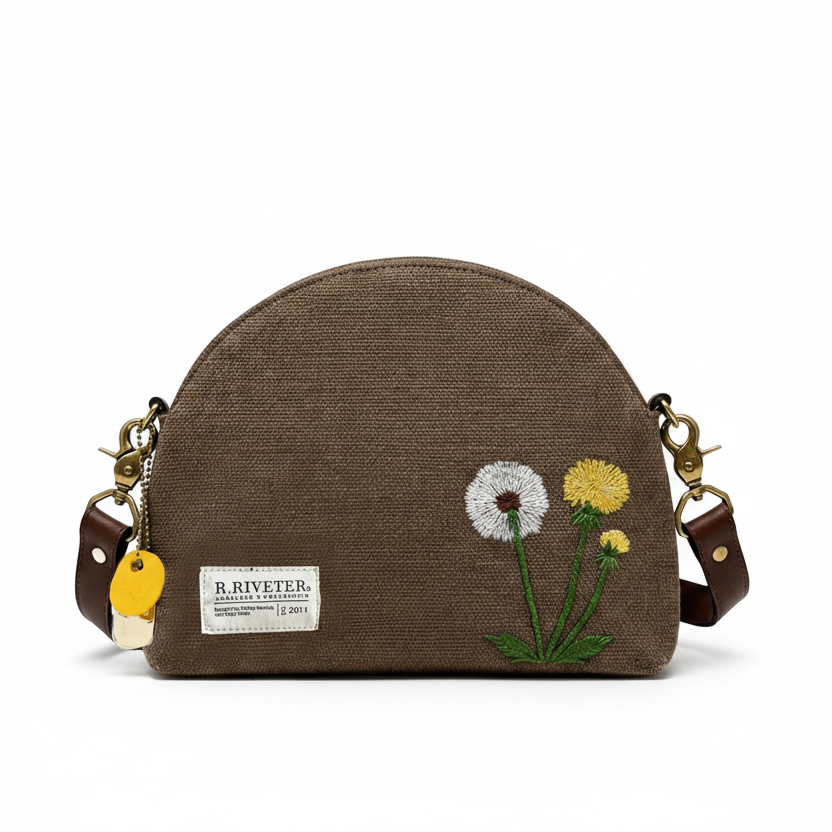 Brown canvas dome crossbody bag with embroidered flowers and two side leather straps