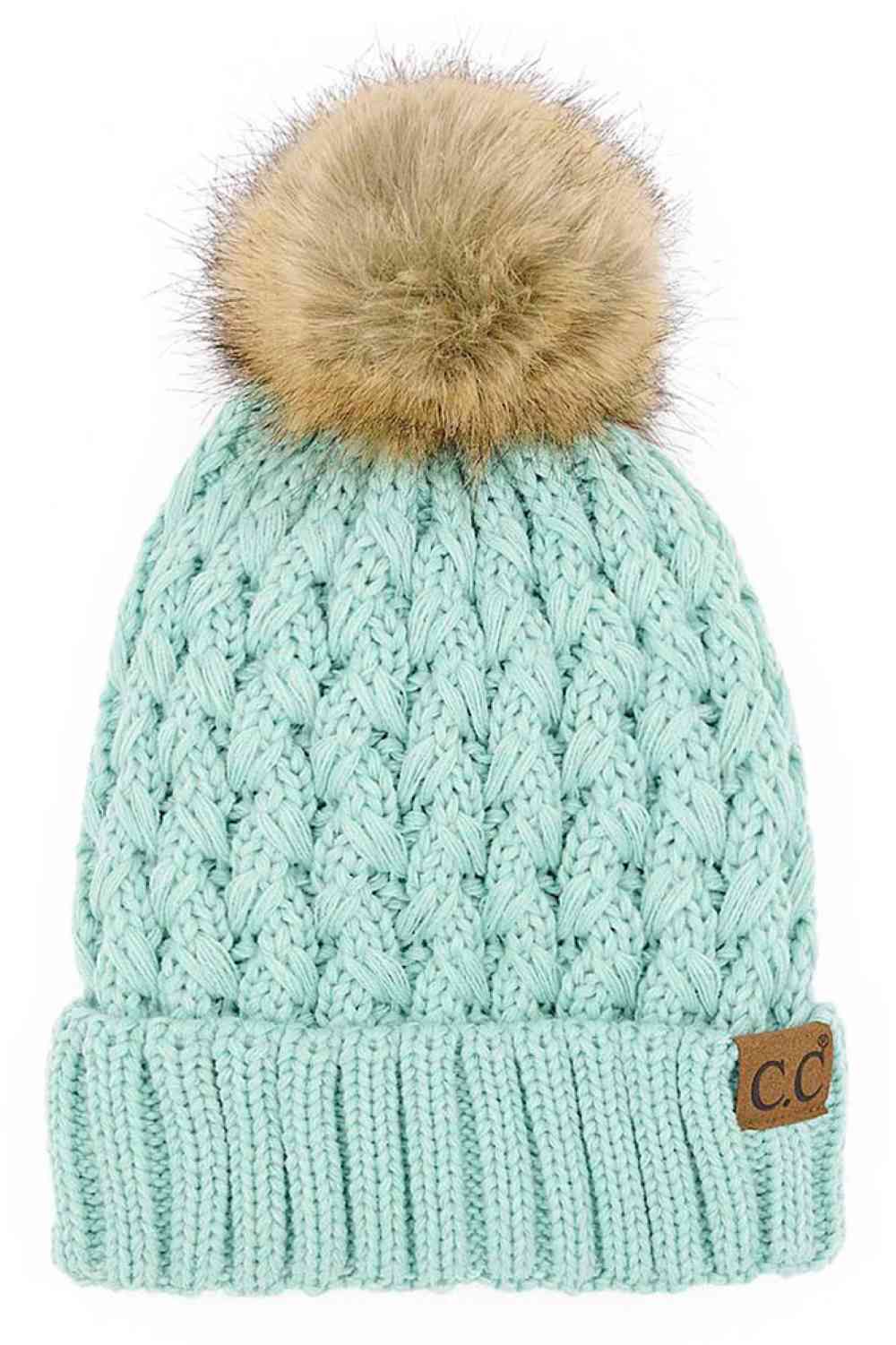Light teal knitted beanie with fluffy pom-pom and C.C patch on ribbed cuff.