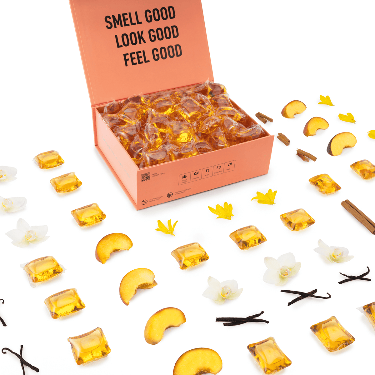 Open orange box showing amber scented detergent pods with scattered pods