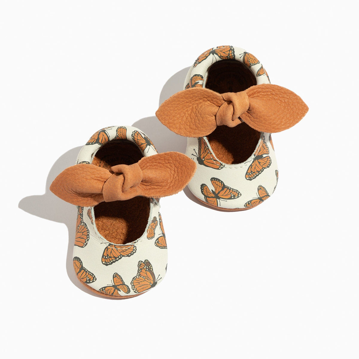 Monarch butterfly baby shoes with knotted bow, white upper with orange butterfly print