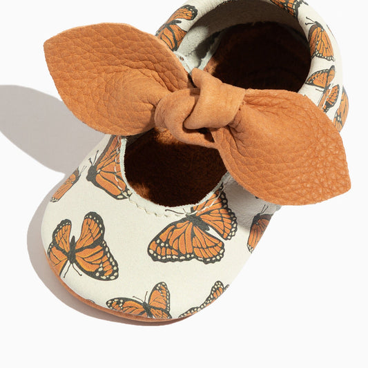 Knotted bow baby shoes, white fabric with orange monarch butterfly print and tan trim