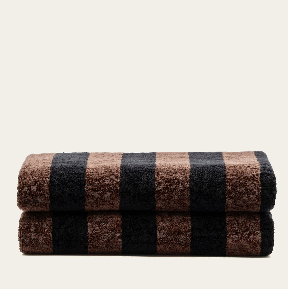 Two rolled towels in brown and black striped pattern