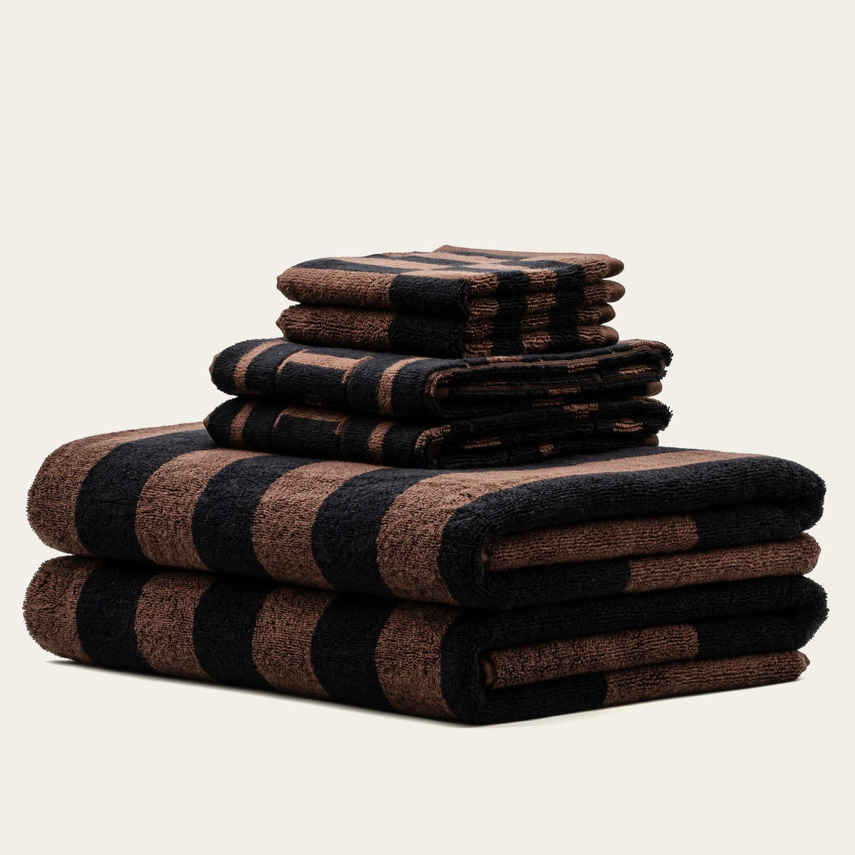 Folded bath towels in tobacco brown and black plaid stripes, stacked set