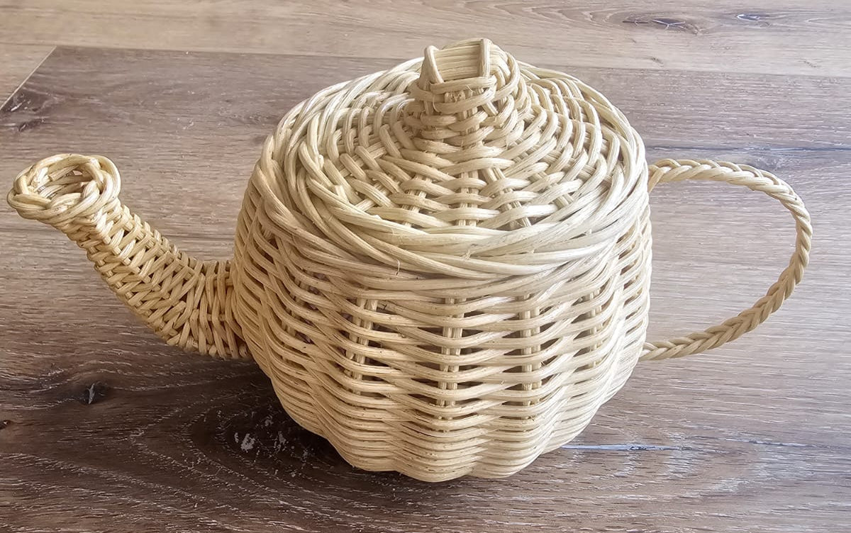Wicker toy teapot with woven lid, curved spout, and loop handle