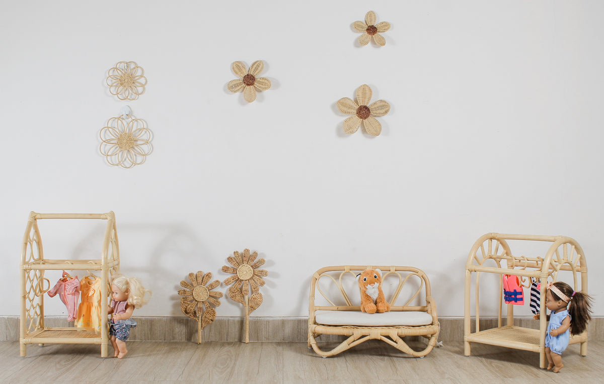 Pair of rattan flower stems displayed on a nursery wall